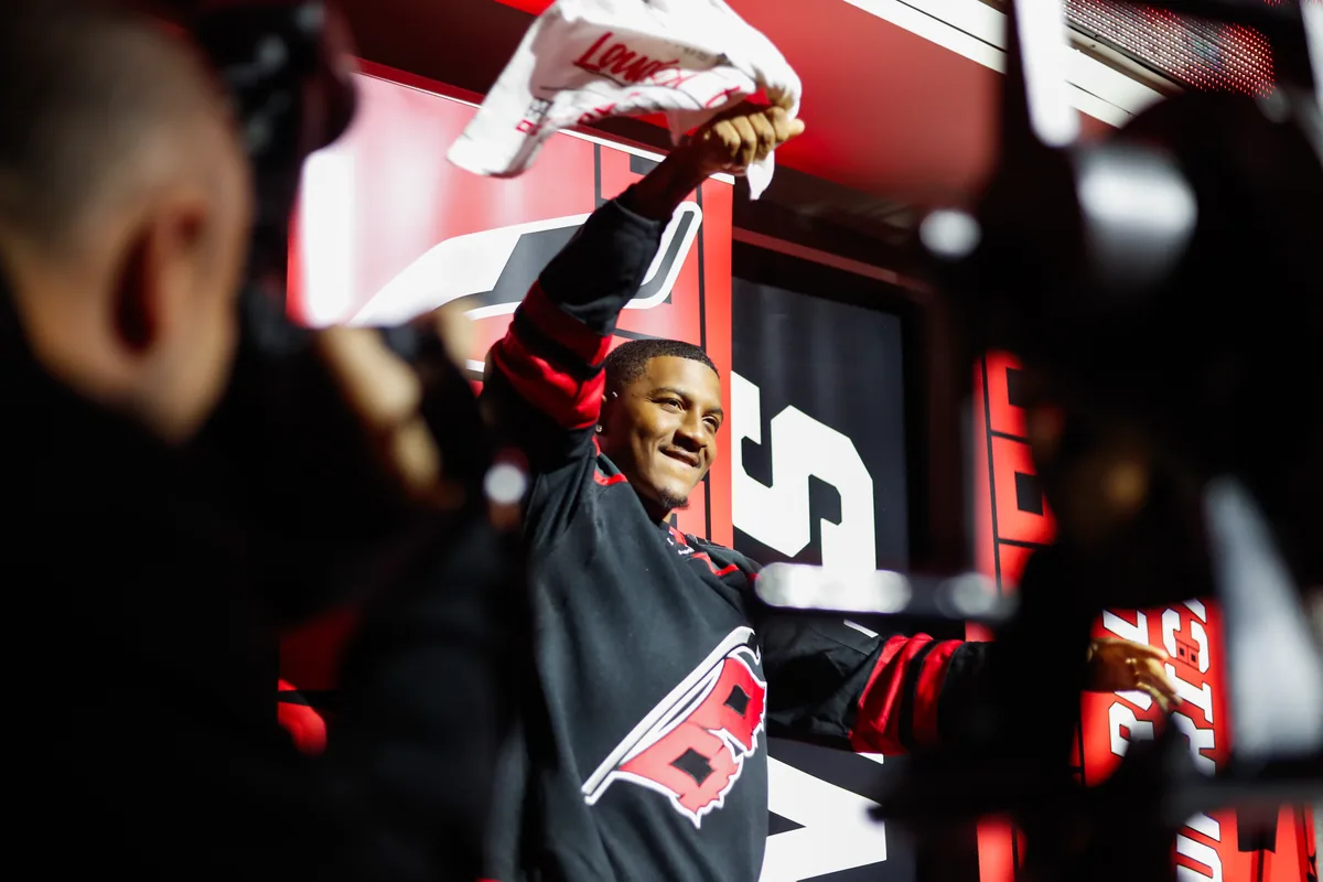 Client waving a rally towel to the crowd at a Carolina Hurricanes game